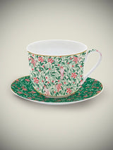 taza-de-porcelana-con-plato-de-desayuno-hojas-y-pajaros