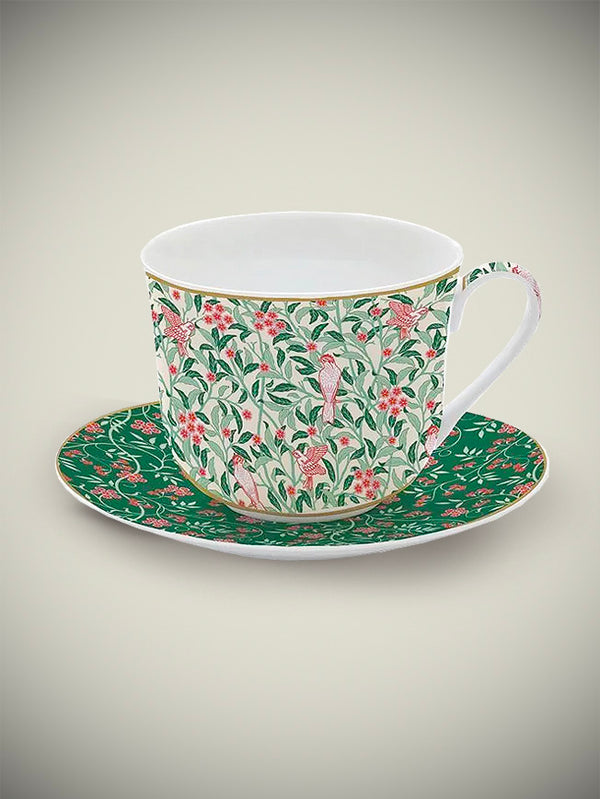 taza-de-porcelana-con-plato-de-desayuno-hojas-y-pajaros